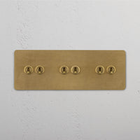 Corston-Kipphebelschalter 6x in Dreifachrahmen – Antikes Messing