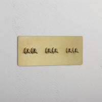 Corston-Kipphebelschalter 6x in Dreifachrahmen – Antikes Messing