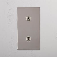 Corston-Kipphebelschalter 2x in vertikalem Zweifachrahmen – Poliertes Nickel