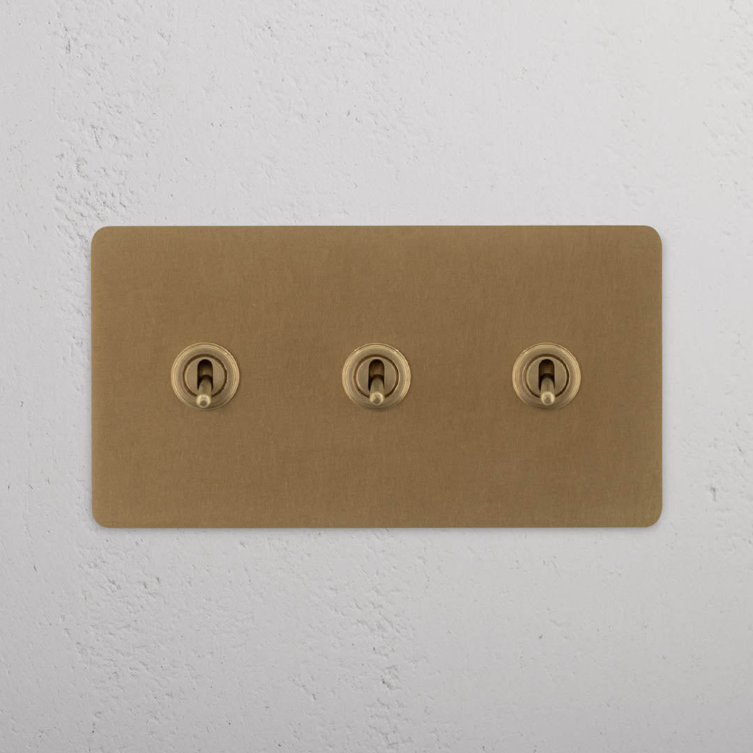 Corston-Kipphebelschalter 3x in Zweifachrahmen – Antikes Messing