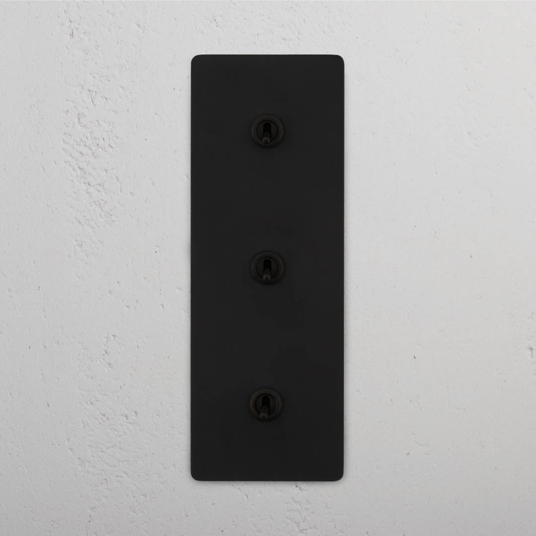 Corston-Kipphebelschalter 3x in vertikalem Dreifachrahmen – Bronze